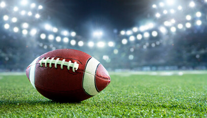 American football field with closeup on ball and stadium lights. Sports background