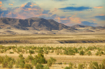 Steppe, prairie, plain, pampa. Majestic mountain peaks overlooking vast expanses of golden sand...