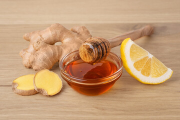 Honey, ginger and lemon on wood background. Natural medicine for cold and cough