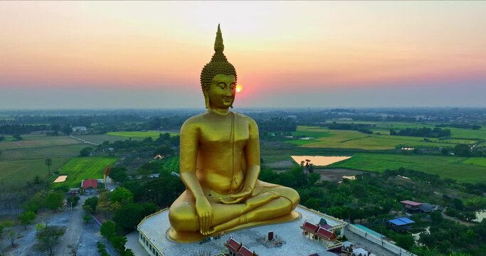 .The largest Buddha statue in the world at wat Muang Ang Thong Thailand. .landmark of Buddhism in Thailand at sunset..video 4K Nature video High quality footage for worship and travel concept.