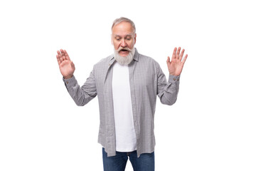 a cute grandfather with a white beard and mustache is wearing a striped shirt over a t-shirt