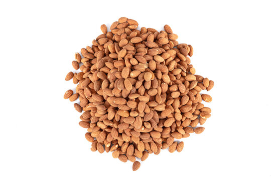 A portion of hickory smoked almonds isolated on a white background. Background of large raw shelled almonds, arranged randomly shot large, shelled nuts for vegans.