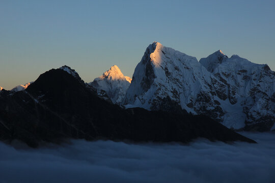 Sun lit mountains Ama Dablam and Cholatse at sunset, Nepal.