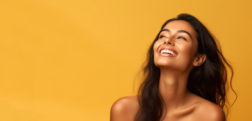 Portrait of young happy Indian woman, Skin care beauty, skincare cosmetics, dental concept, isolated over yellow background. Copy space.