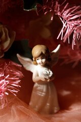 Angel figurine near the Christmas tree. Selective focus
