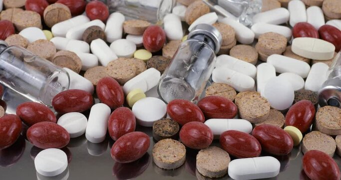 Pharmacy background on a metal surface. Tablets, pills, glass flacons and ampoule. Medicine and healthy. Close up of capsules.