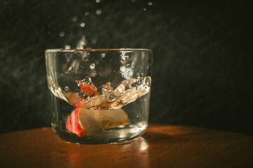 Apple thrown in the water with dimm background 