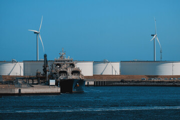 Modern LNG Tanker For Bunkering. LNG Vessel During Cargo Operations In The Trade Port. Natural Gas Transportation. Bunkering Vessel During Shore-To-Ship Fuel Supply Operation At The LNG Terminal © I am from Mykolayiv