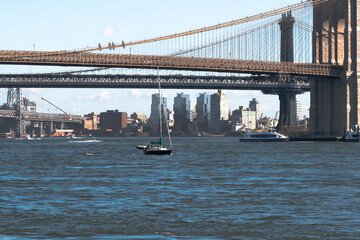 Fototapeta na wymiar The Manhattan bridge and the Brooklyn Bridge as seen from a ferry on the East River