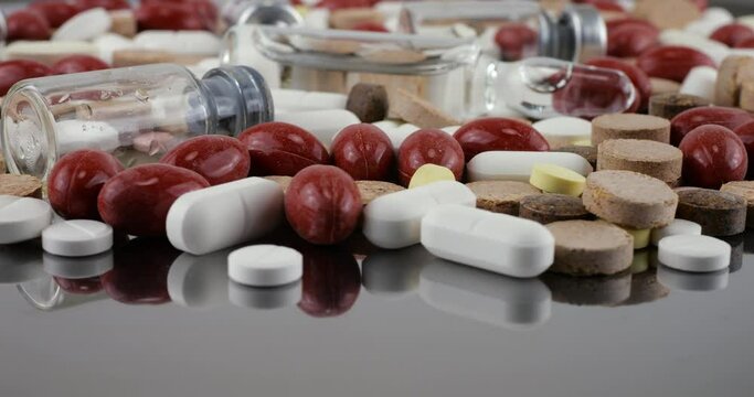 Pharmacy background on a metal surface. Tablets, pills, glass flacons and ampoule. Medicine and healthy. Close up of capsules.