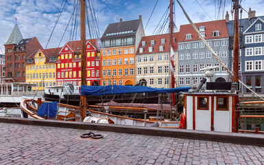 Copenhagen. Nyhavn canal colorful traditional houses and city embankment at sunrise.