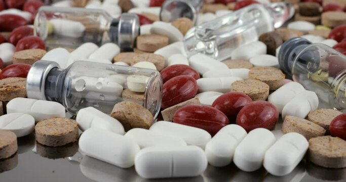 Pharmacy background on a metal surface. Tablets, pills, glass flacons and ampoule. Medicine and healthy. Close up of capsules.