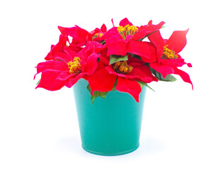 Closeup red poinsettia arrangement made with classic red plants, and a green color metal planter pot. Merry Christmas holiday decor.  Fake, not real, fabric easy to make isolated on white background