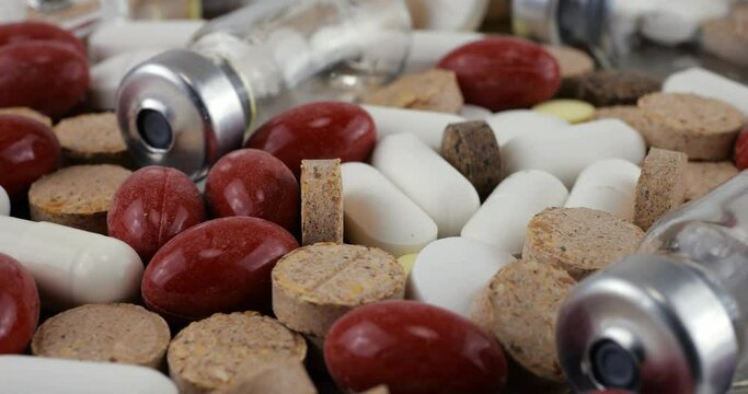 Pharmacy background on a metal surface. Tablets, pills, glass flacons and ampoule. Medicine and healthy. Close up of capsules.