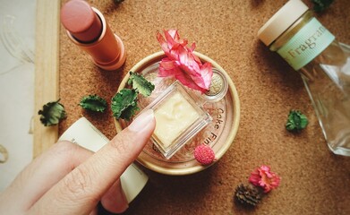 Lip scrub. The hand touching lip scrub.