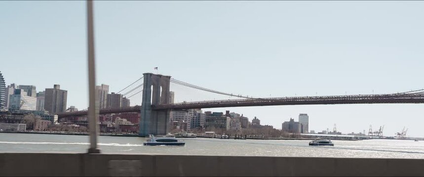 4K 2.39 60@24fps_NYC Driving Shot of Brooklyn Bridge and Ferries in the East River