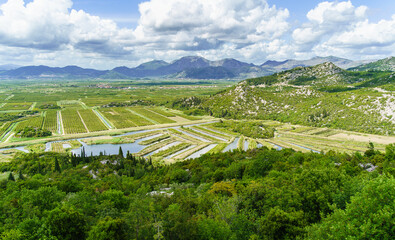 Aerial view of beautiful fertile Neretva valley surrounded by mountains, also called the garden of...