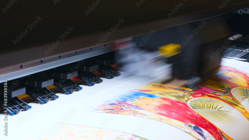 Poster a moving working industrial wide format printer prints a color picture on paper.
