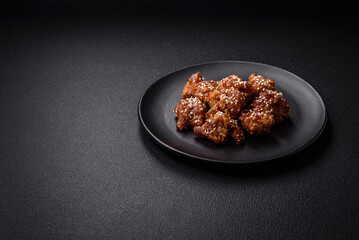 Delicious Asian dish with pieces of chicken in teriyaki sauce with salt and spices