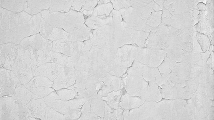 white wall with cracked paint as a textured abstract background for a page, template or web banner