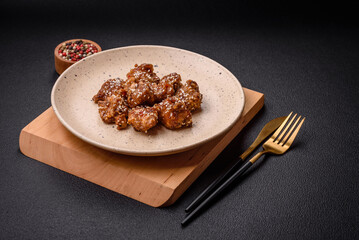 Delicious Asian dish with pieces of chicken in teriyaki sauce with salt and spices