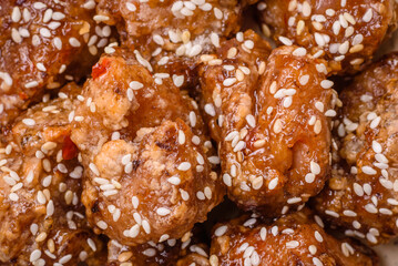 Delicious Asian dish with pieces of chicken in teriyaki sauce with salt and spices