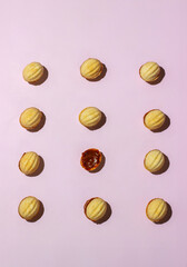 pattern on a pink background cookies nuts with chocolate cream 