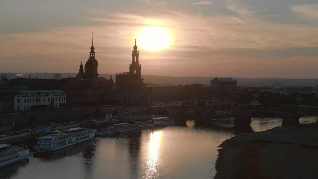 Smooth aerial top view flight drone. Sunset town Dresden Cathedral Bridge River