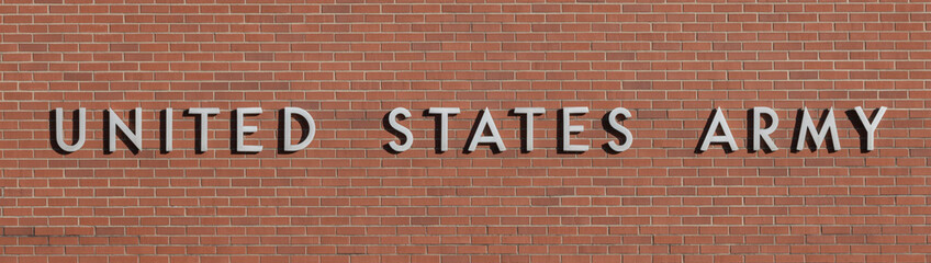 UNITED STATES ARMY banner in stainless steel text against a brick background. The Army is a branch of the US military.