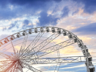 White Ferris wheel against the blue sky.