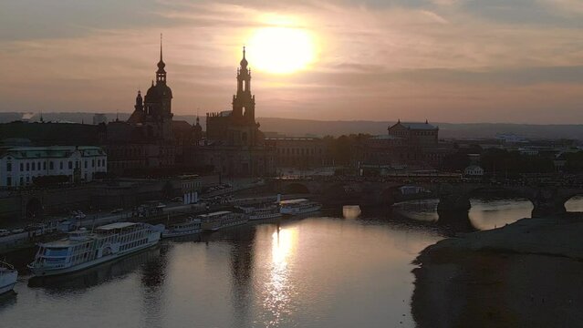 Lovely aerial top view flight drone. Sunset town Dresden Cathedral Bridge River