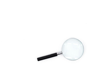 A photo featuring a magnifying glass with a black handle and a silver rim around the magnifying...