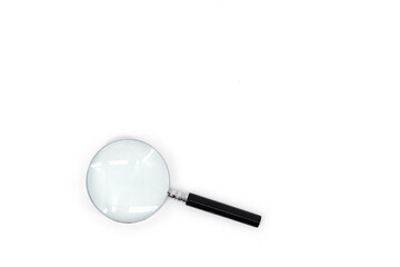 A photo featuring a magnifying glass with a black handle and a silver rim around the magnifying...