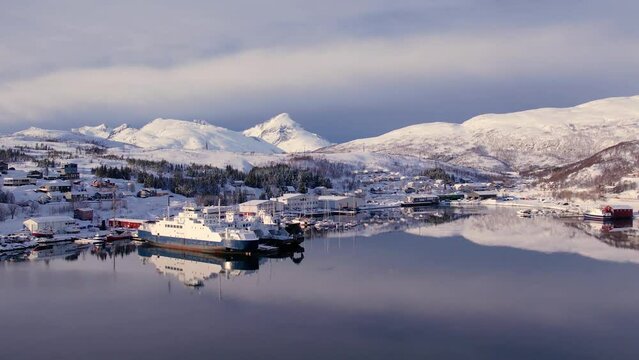 Aerial drone view of fishing boat in the port of northern Norway, Tromso. Sunny winter day
