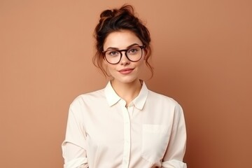 attractive woman with glasses on beige background