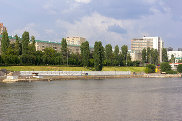 Fototapeta na wymiar embankment of a large city along the river in summer