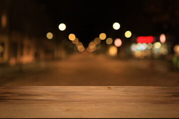 Beautiful empty wood table top counter, window view. Wooden table with blur bokeh background ready for product montage. Abstract blurred bokeh neutral background of city, shop, store, restaurant, city