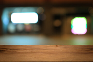 Beautiful empty wood table top counter, window view. Wooden table with blur bokeh background ready for product montage. Abstract blurred bokeh neutral background of city, shop, store, restaurant, city