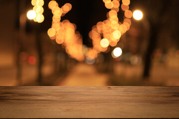 Beautiful empty wood table top counter, window view. Wooden table with blur bokeh background ready for product montage. Abstract blurred bokeh neutral background of city, shop, store, restaurant, city