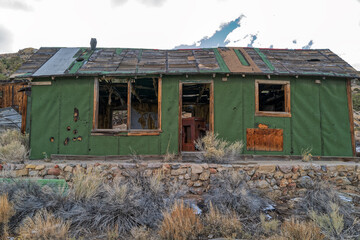 Green tar paper lines the outer walls of an abandoned mining shack in Nevada, USA