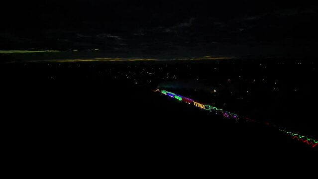 Paignton, Torbay, South Devon, England: DRONE VIEWS: Torbay Steam Railway's annual Christmas Train of Lights weaves through Devon countryside. The Train of Lights is a popular UK tourist attraction.