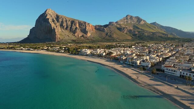 Aerial shot of famous San Vito Lo Capo - beach and town in Sicily, Italy. Beach with turquoise water at the foot of the mountain in San Vito Lo Capo - tourist pearl of western Sicily