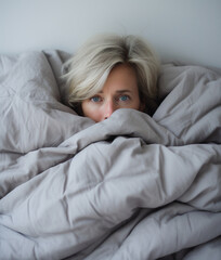 Mature woman wrapped up in blanked