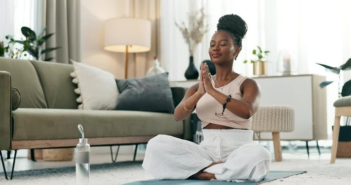 Yoga, lotus or black woman in meditation in home praying for wellness, calm peace or balance. Lounge, relax or zen African person in pilates pose for energy training, breathe or holistic exercise