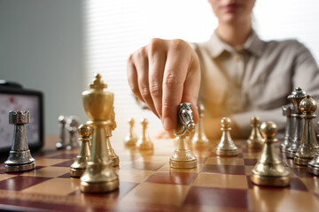 Woman playing chess during tournament at chessboard, closeup