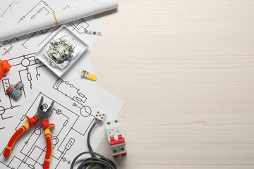 Flat lay composition with wiring diagrams on white wooden table, space for text
