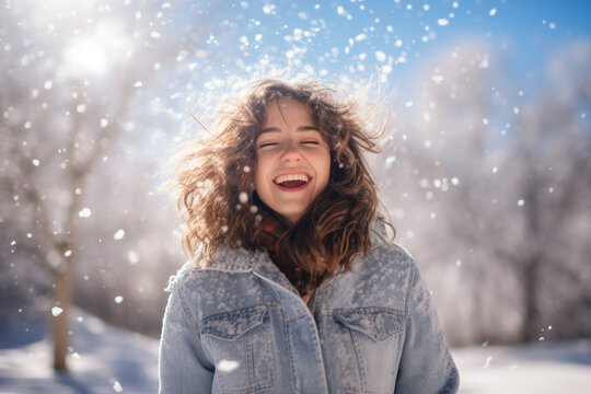 Portrait of a happy brunette woman with a smile outdoors in winter on a snowy day. High quality photo