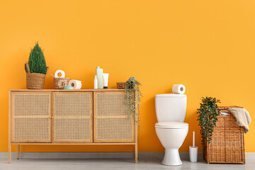 Stylish interior of modern restroom with wicker laundry basket and bath supplies