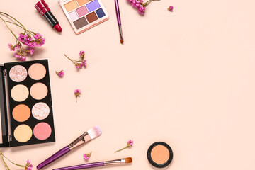 Composition with different makeup products and beautiful flowers on pink background