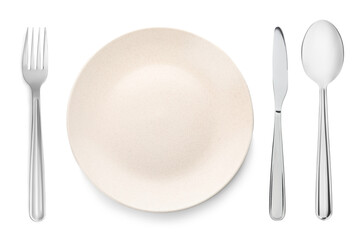 Empty beige plate with fork, knife and spoon on white background, top view